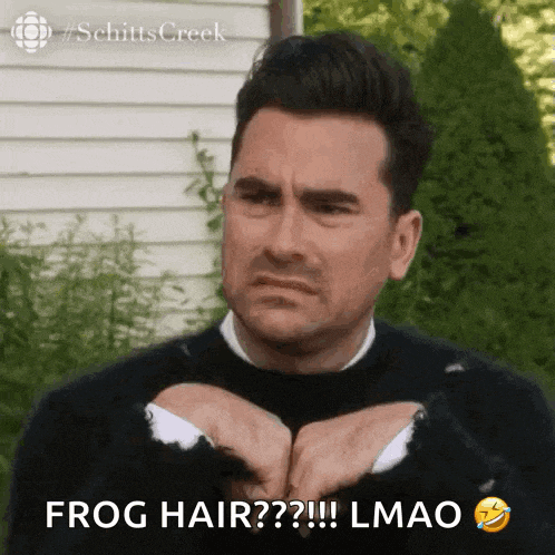 a man in a black sweater is making a funny face and says frog hair ? !! lmao .