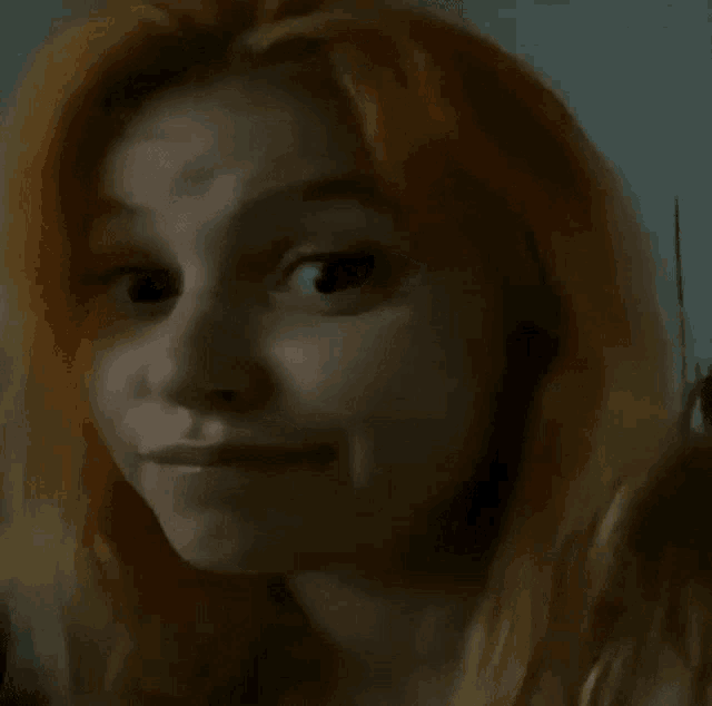 a woman with red hair making a funny face