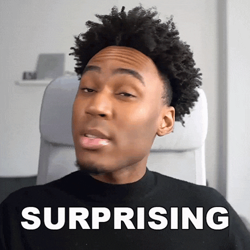 a man with a surprised look on his face is sitting in a chair next to the word surprising