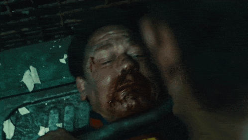 a close up of a man 's face in a dark room