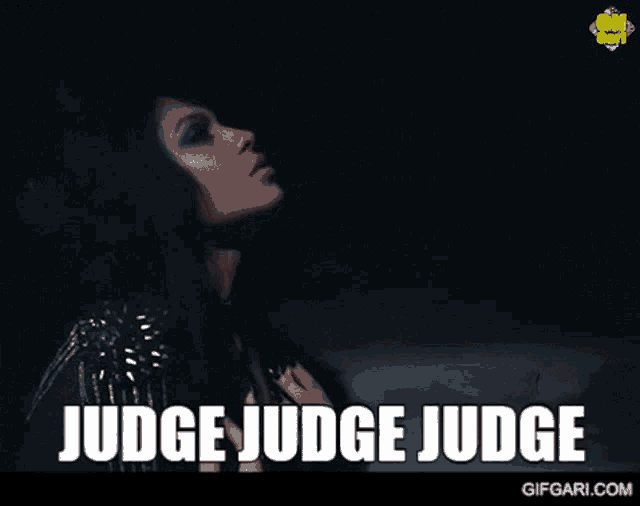a woman in a dark room with the words " judge judge judge " on the bottom