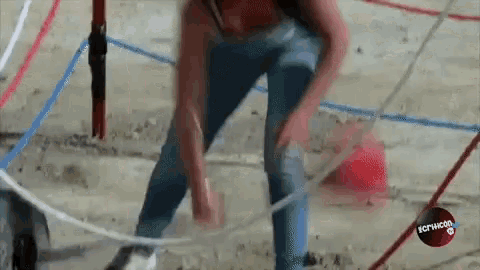 a person is playing with a hula hoop on a concrete surface with a red circle that says ictvicon on it