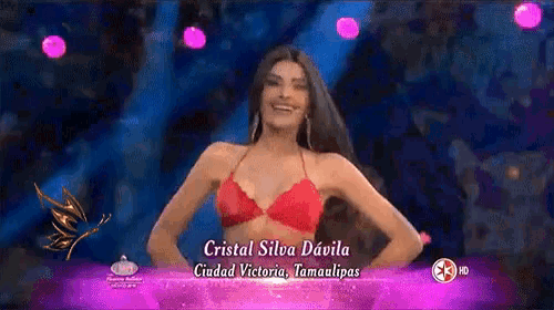 a woman in a red bikini is on a stage and the name cristal silva davila is on the screen