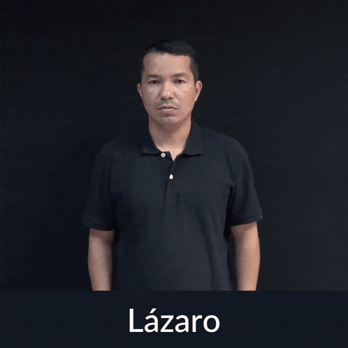 a man in a black shirt is making a sign with his hands that says lazaro