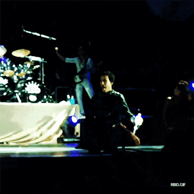 a man sitting on a stage with the words rbd.gif visible in the corner