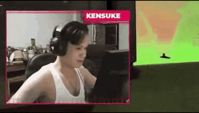 a person wearing headphones is playing a video game with the name kensuke on the screen