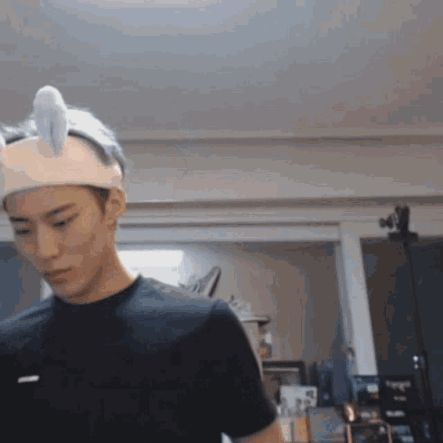 a young man wearing a headband with bunny ears on it .