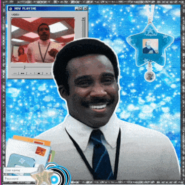 a man in a white shirt and tie smiles in front of a computer screen that says now playing