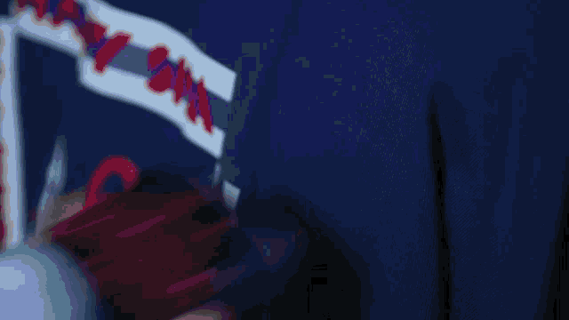a person is holding a glowing object with the letter s on it in their hand