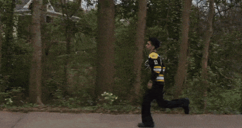 a man in a black and yellow jersey with the number 12 on it