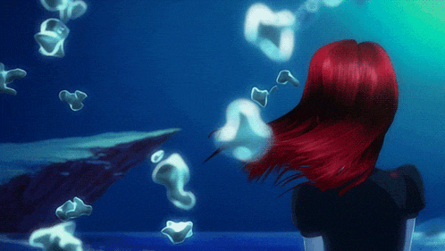 a woman with red hair is standing in the ocean