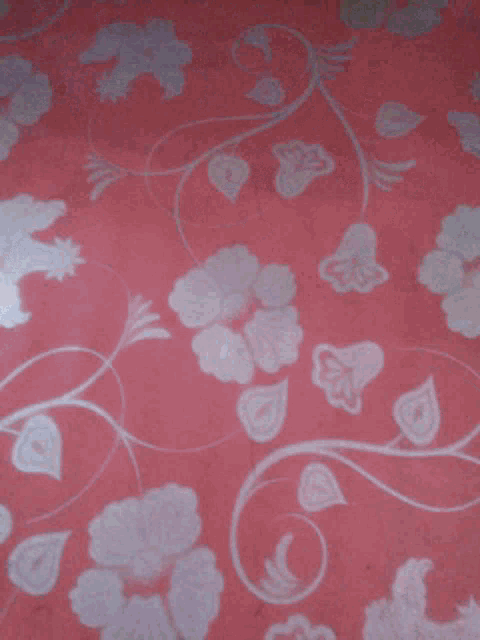 a person is giving a thumbs up on a pink floral background