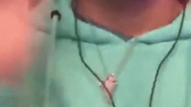 a blurred image of a person 's face with a green background