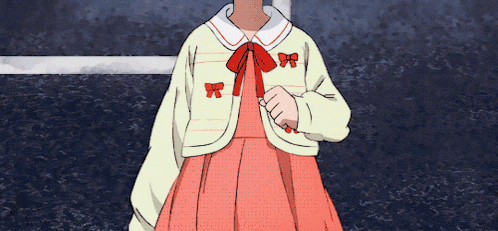 a girl wearing a pink dress and a yellow jacket with red bows on the sleeves