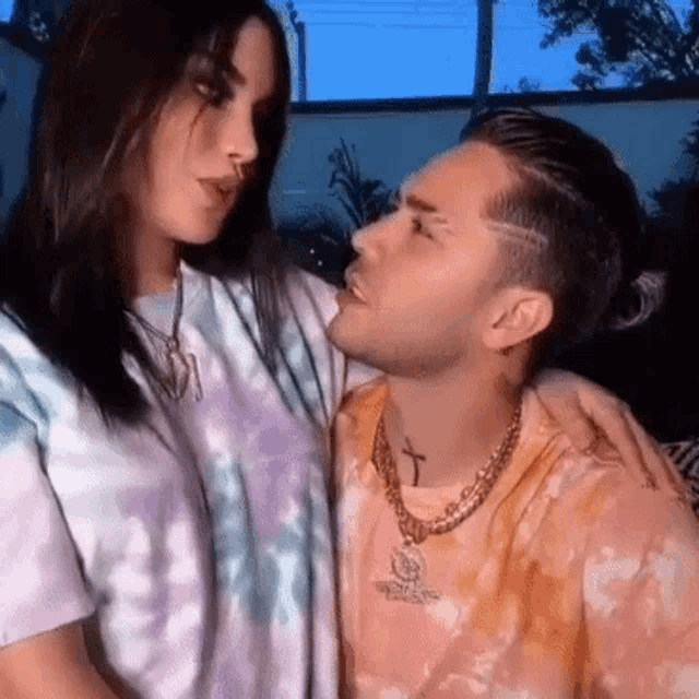 a man and a woman are looking at each other .