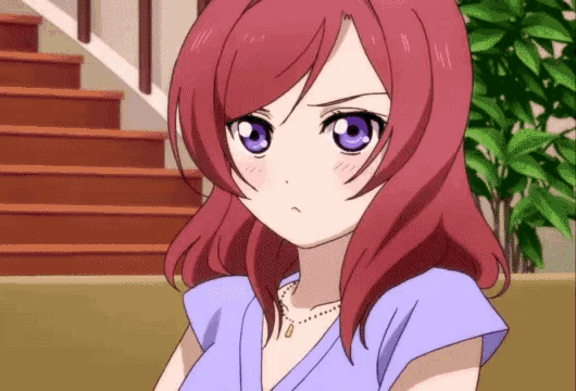 a girl with red hair and purple eyes is wearing a purple shirt