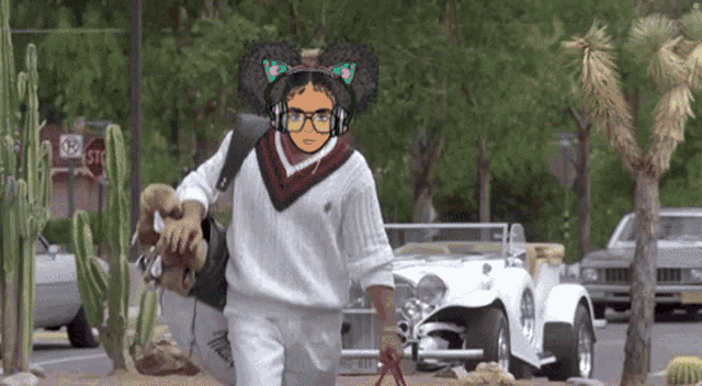 a person wearing headphones and a cat ear headband walks down a street with a stop sign in the background