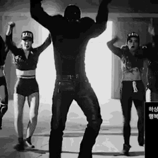 a black and white photo of a group of people dancing .