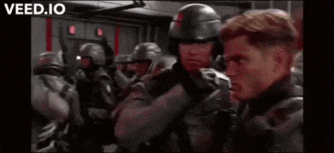 a man with red hair is talking to lieutenant john rico .