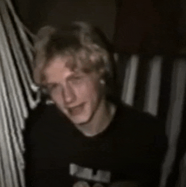 a blurry picture of a young man wearing a black shirt that says palm