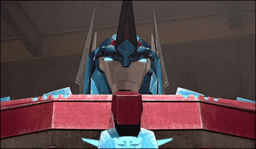 a close up of a robot with blue eyes and a red chest