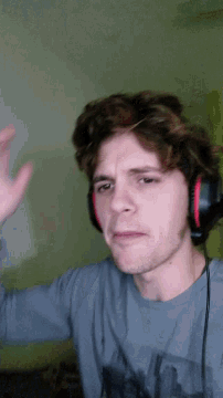 a man wearing headphones and a gray shirt
