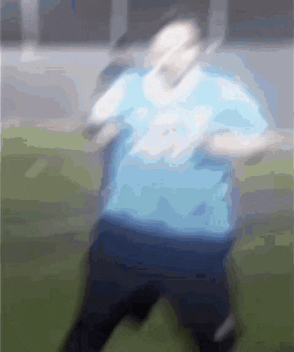 a blurry picture of a person wearing a blue shirt that says ' ucsd ' on it