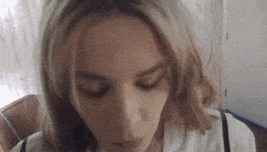 a close up of a woman giving a blowjob with her eyes closed
