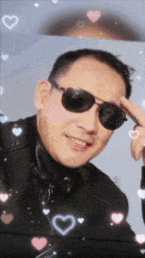 a man wearing sunglasses is surrounded by hearts and sparkles
