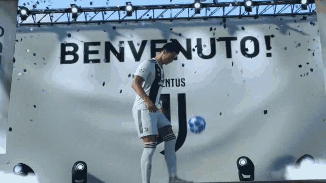a soccer player in front of a benvenuto sign