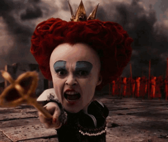 queen of hearts from alice in wonderland is holding a key