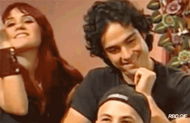 a man and a woman are sitting next to each other with rbd.gif written on the bottom of the image