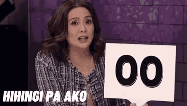 a woman is holding a sign with the number 00 on it