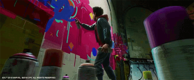 a man is painting on a wall that says " all in " on it