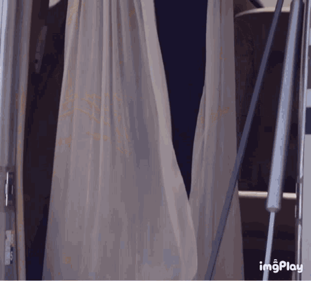 a white curtain is hanging on a staircase with imgplay written on the bottom right