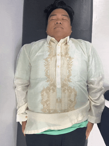 a man laying on a bed with his eyes closed