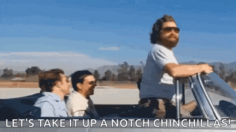 a man with a beard is driving a convertible with two other men .