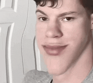 a young man is making a funny face with his mouth open and his tongue sticking out .
