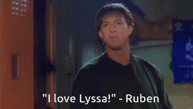 a man in a black shirt says " i love lyssa " ruben is behind him