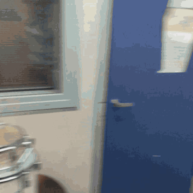 a blurry picture of a blue door in a room