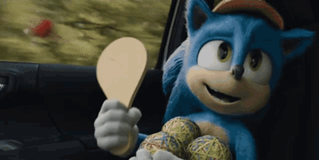 sonic the hedgehog is sitting in the back seat of a car holding a wooden paddle .