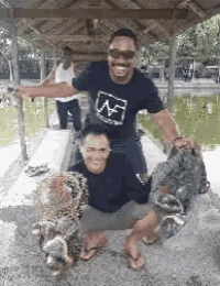a man and a woman are posing for a picture with fishing nets .