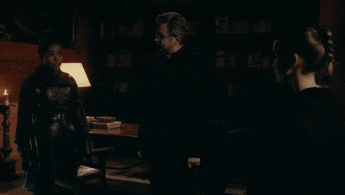 a group of people standing in a dark room with the words i drink a lot written on the bottom