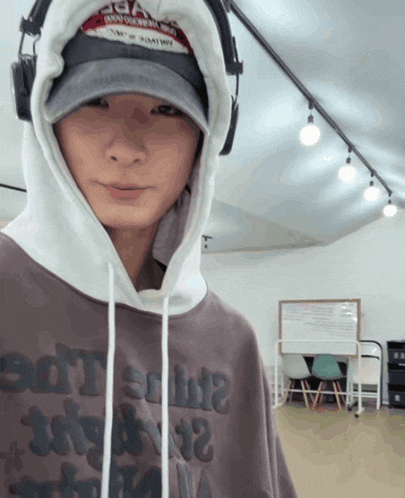 a man wearing headphones and a hoodie that says ' a ' on it