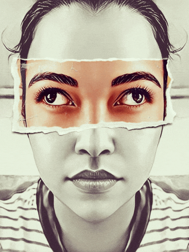 a close up of a woman 's face with a piece of paper covering half of her eyes