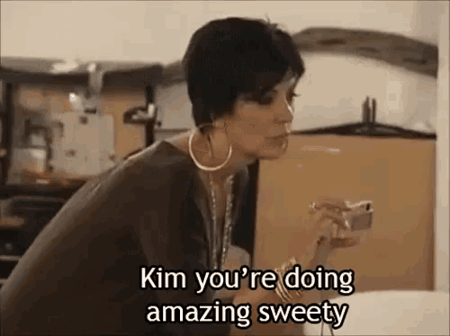 a woman is smoking a cigarette and saying `` kim you 're doing amazing sweety ''