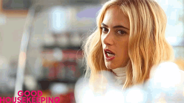 a woman with blonde hair and a white turtleneck with the words good housekeeping on the bottom