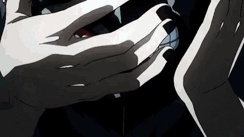 a close up of a person 's hands with long nails holding something in a dark room .