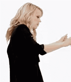 the woman is wearing a black dress and a black jacket .