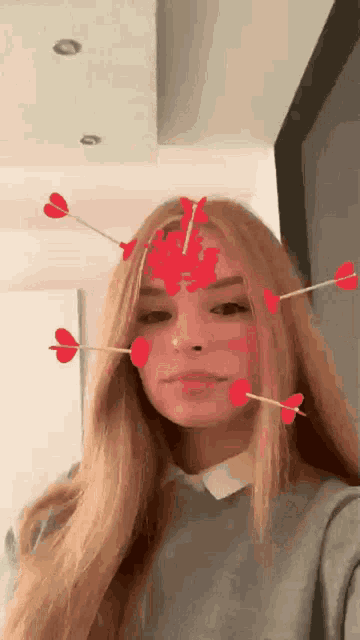 a woman with arrows in her face and hearts on her face